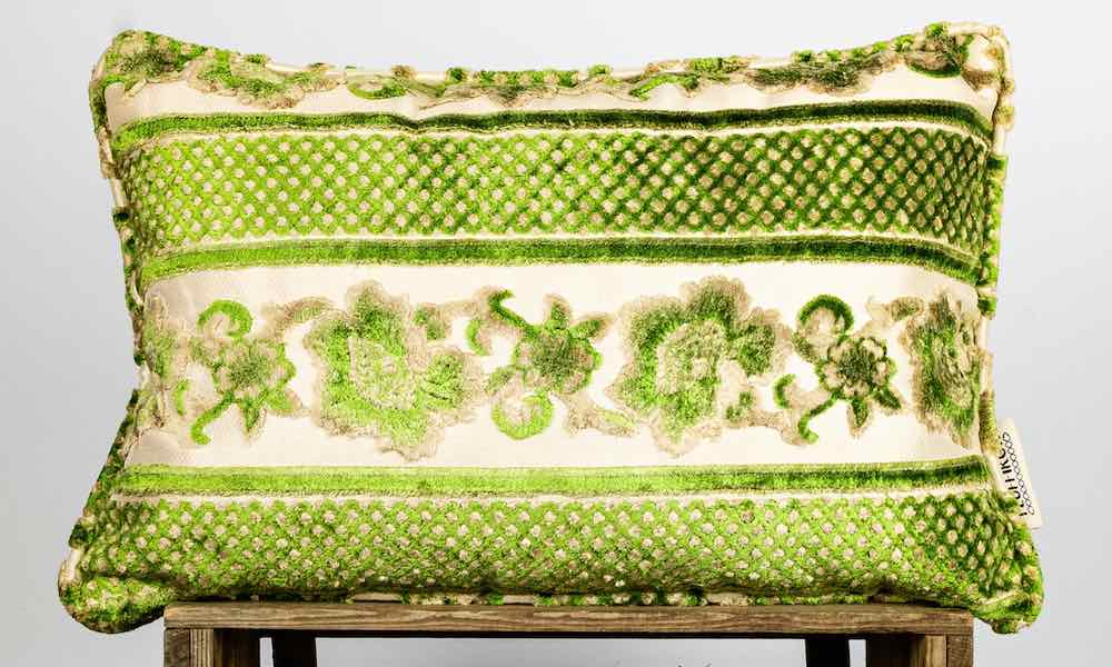 Close view on a green velvet sofa pillow.