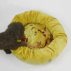 Video of a dog entering and sleeping in a donut dog bed.