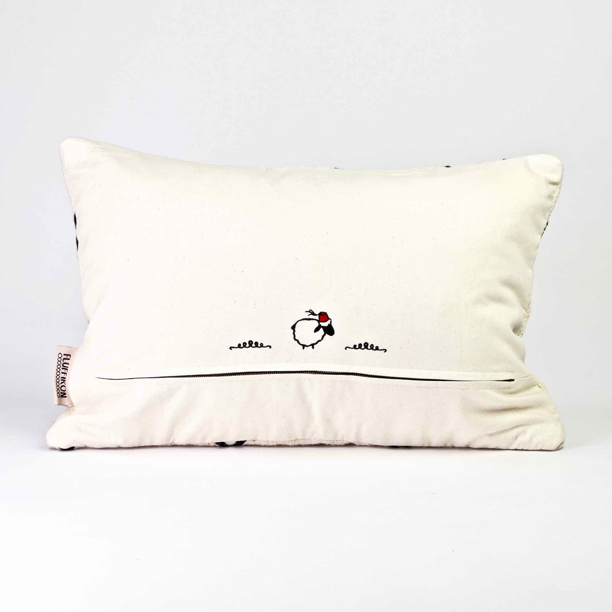 Back view of a black and white Fluffikon Kilim throw pillow.