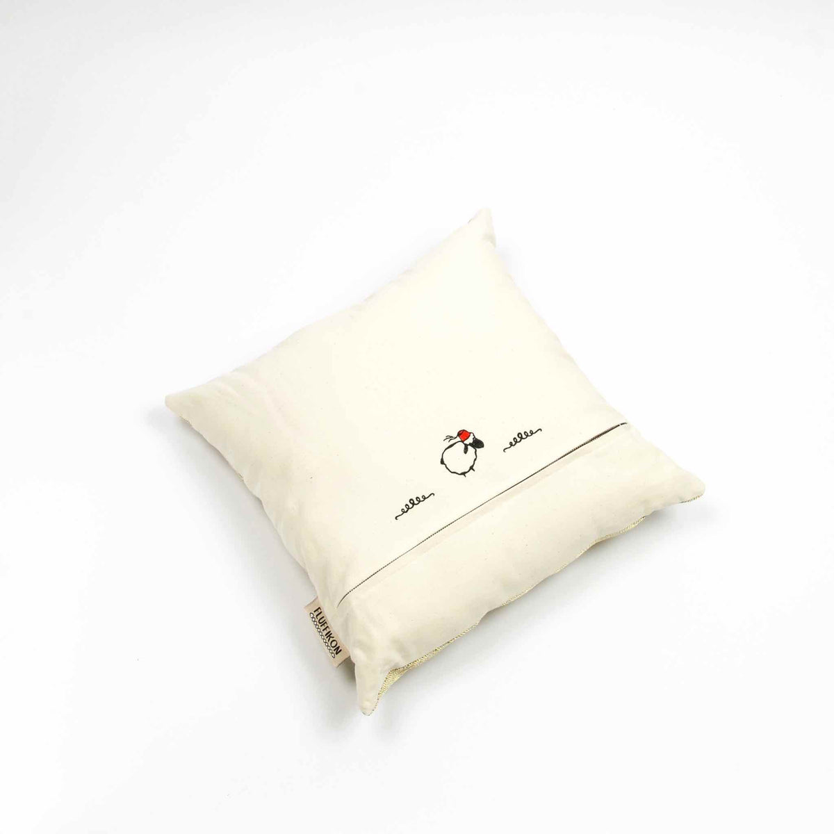 Fluffikon silk square pillow made from golden moroccan fabric. The throw pillow is shown from the back.