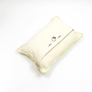 Fluffikon velvet rectangular pillow made from beige moroccan fabric. The pillow is on the ground shown from the top. The pillow back is shown.