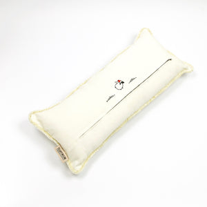 Fluffikon velvet lumbar pillow made from beige moroccan fabric. The pillow is on the ground shown from the top. The pillow back is shown.
