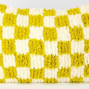 Zoom on yellow-white checkered Fluffikon pillow made from a Beni Ourain carpet.