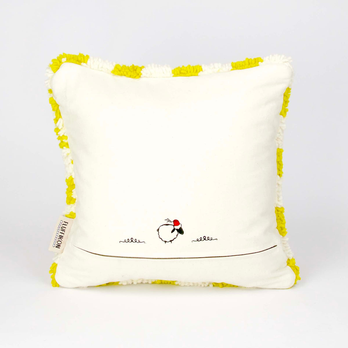 The back view on a Beni Ourain Fluffikon pillow with yellow white checkered pattern. The pillow is made from wool. It stands in front of a white background.