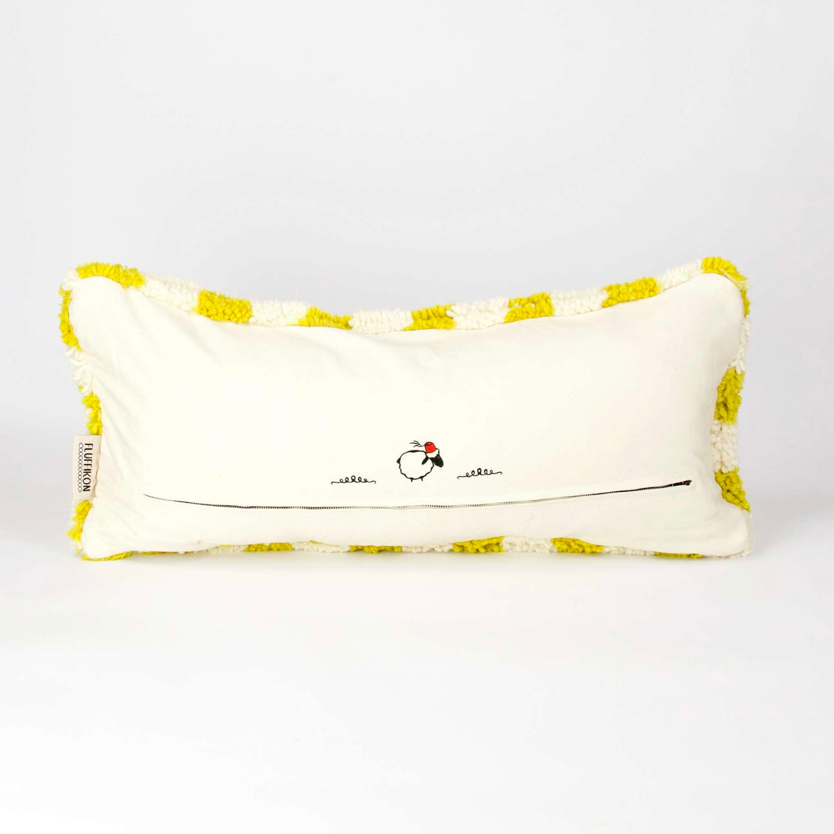 View on the back of a Beni Ourain Fluffikon lumbar pillow with yellow white checkered pattern made from a  wool carpet.