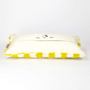 Side view of a Beni Ourain Fluffikon lumbar pillow with yellow white checkered pattern made from a  wool carpet.
