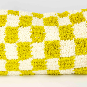 Zoom on Beni Ourain Fluffikon lumbar pillow with yellow white checkered pattern made from a  wool carpet.