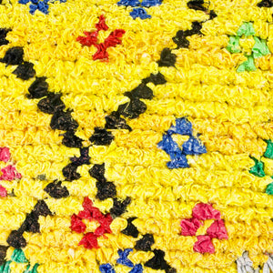 Close-up zoom on a yellow Fluffikon Berber Cushion Cover. The pillows is made from an upcycled Boucherouite rug.