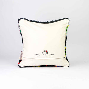 The back of a black Boucherouite Berber Cushion cover with colorful spots.