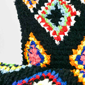 Two black Boucherouite Berber Cushions cover with colorful spots.