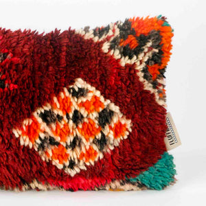 Vintage Berber pillow in red. The right part of the lumbar cushion is shown.
