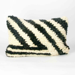 Black and white Fluffikon rug pillow.