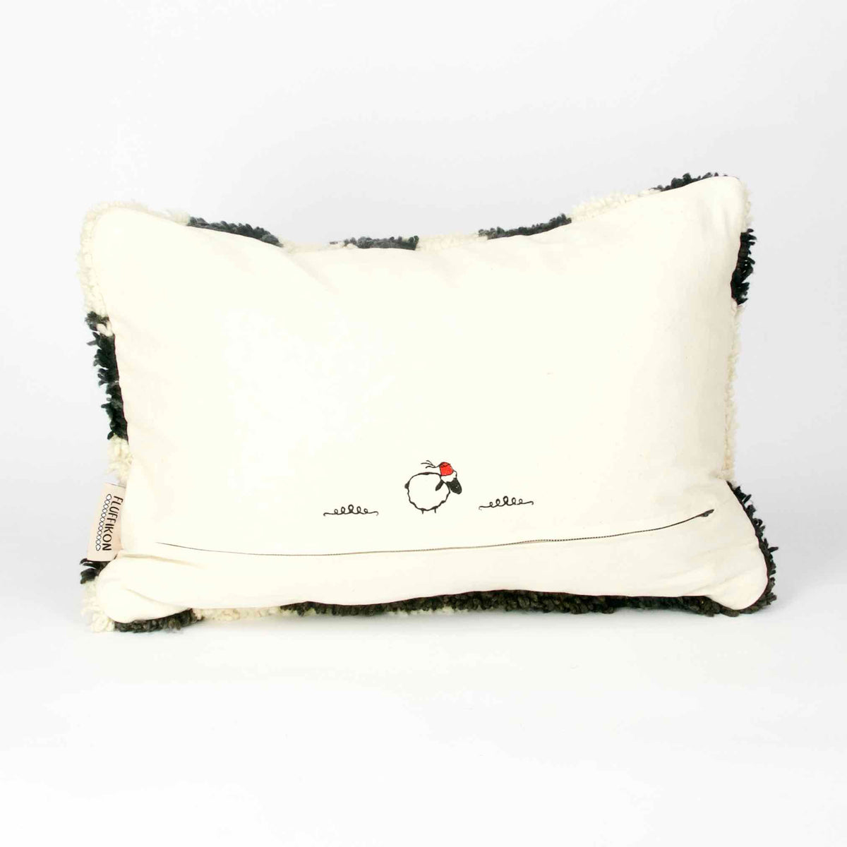 The back of a black and white Fluffikon rug pillow.