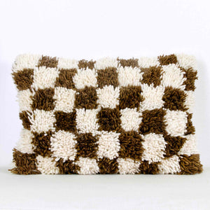Brown checkered Fluffikon throw pillow. The Moroccan pillow  was made from a Berber Beni Ourain wool rug.