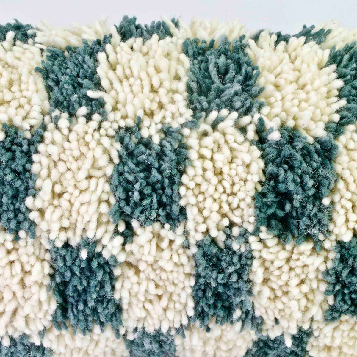 Zoom on the wool of a checkered Moroccan Lumbar Pillow