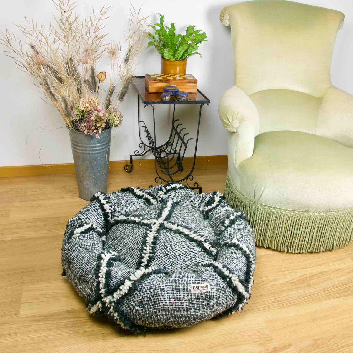 Lifestyle shot. Black and white Fluffikon Kilim Dog Bed in a living room.