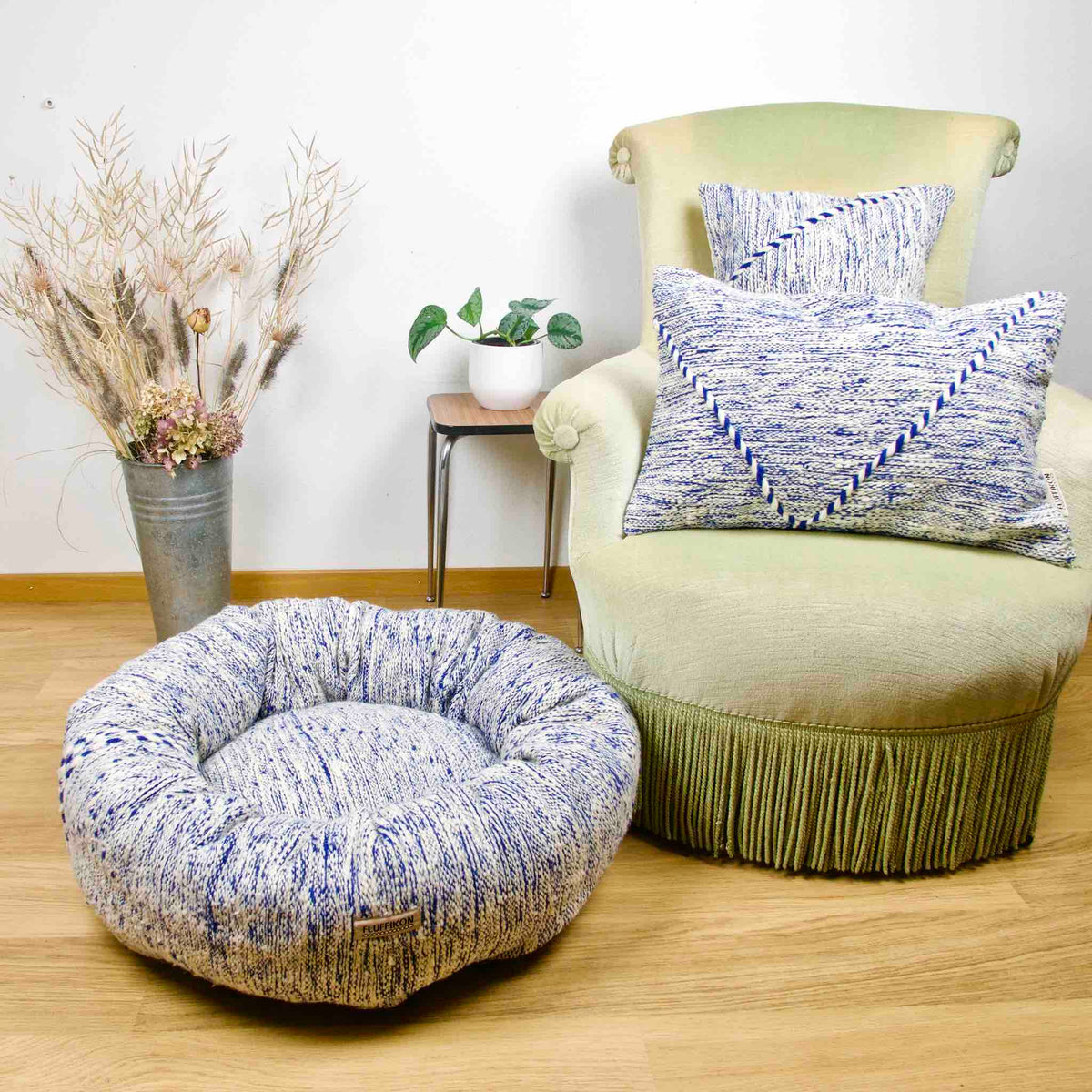 Blue and white Kilim Fluffikon dog bed and two Kilim throw pillows made from the same material.