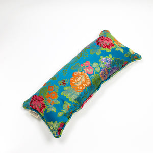Blue decorative lumbar pillow made from shiny brocade with colourful flowers embroidery.