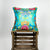 Blue decorative square pillow made from shiny brocade with colourful flowers embroidery. Pillow stands on a wooden box.