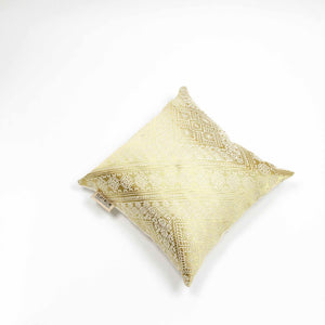 Fluffikon silk square pillow made from golden moroccan fabric. The pillow is shown from the top.