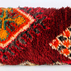 Vintage Berber pillow in red. The middle part of the lumbar cushion is shown. 