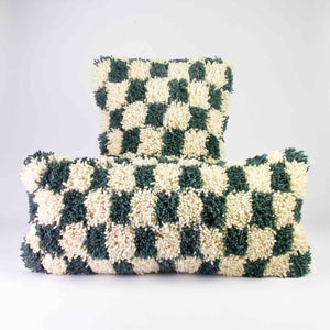 Two checkered Moroccan Lumbar Pillows. The pillows are blue-grey checkered. They are made of a Moroccan wool rug.