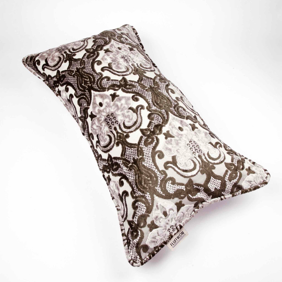 Large couch pillow made from brown beige velvet fabric. The pillow is in front of a white background.