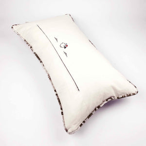 Large couch pillow made from brown beige velvet fabric. The back of the pillow is shown.