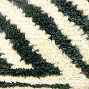 Zoom on the wool of a black and white Fluffikon rug pillow.