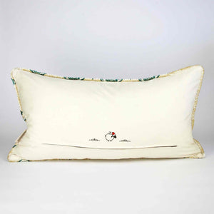 Oversize Fluffikon throw pillow in front of white background. The pillow is shown from the back standing on the ground. 