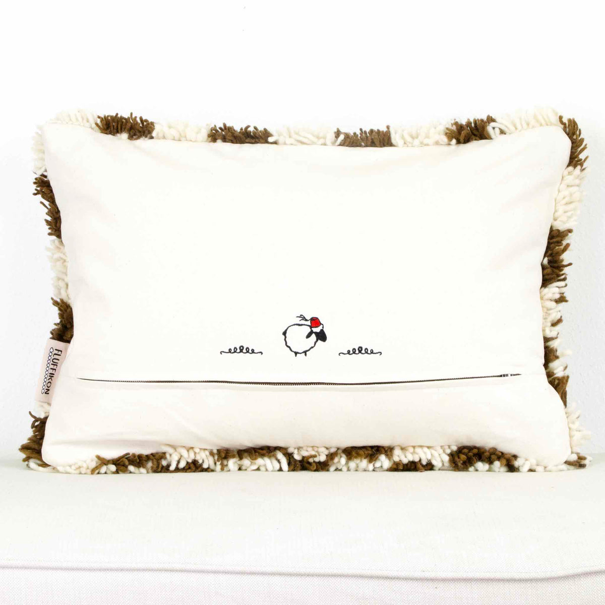 back view on a brown checkered Fluffikon throw pillow.