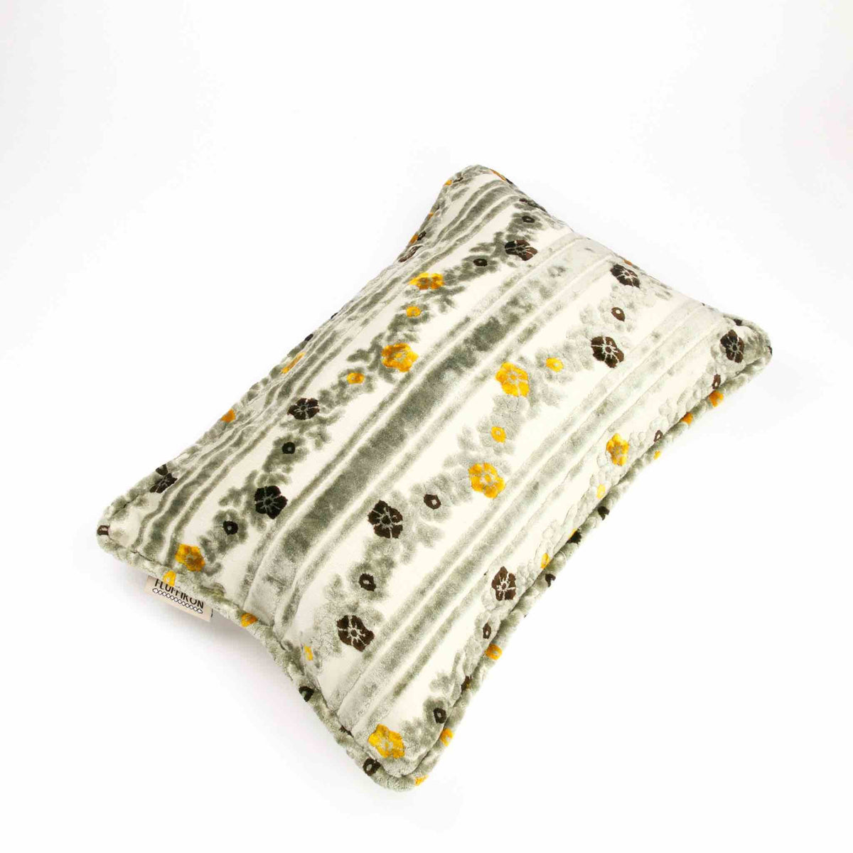 Large decorative pillow made from grey velvet fabric. The Fluffikon pillow is placed on a white background.