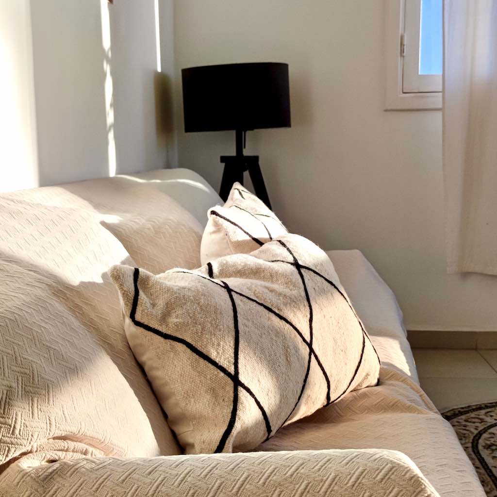 Two Kilim pillow covers during sunset light.