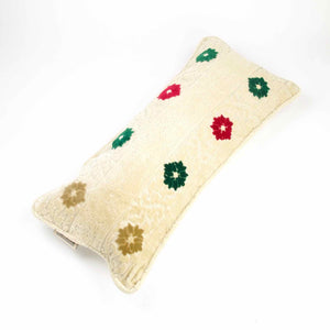 Large Moroccan pillow made from velvet fabric on white background. The fabric has green, red and flowers on a traditional moroccan beige canvas.