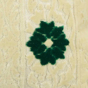Zoom on beige velvet fabric with green velvet flower. The fabric is used for Fluffikon's Blooming Velvet pillows.