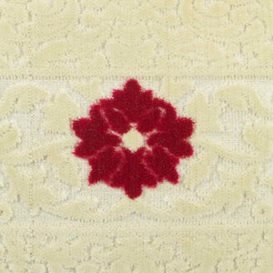 Zoom on beige velvet fabric with red velvet flower on a beige canvas. The fabric is used for Fluffikon's Blooming Velvet pillows.