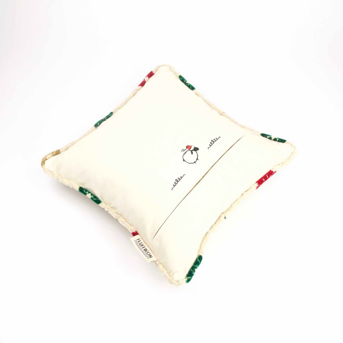 Square velvet pillow lying on a white background.