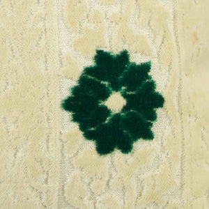 Zoom on green flower of a velvet square pillow.