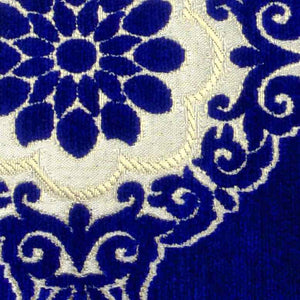 Detailed view on blue velvet pillow with Moroccan tile motif.