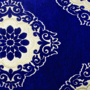 Zoom on blue velvet fabric with Moroccan tile motif.