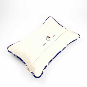 Blue velvet pillow with piped edges on a white background.