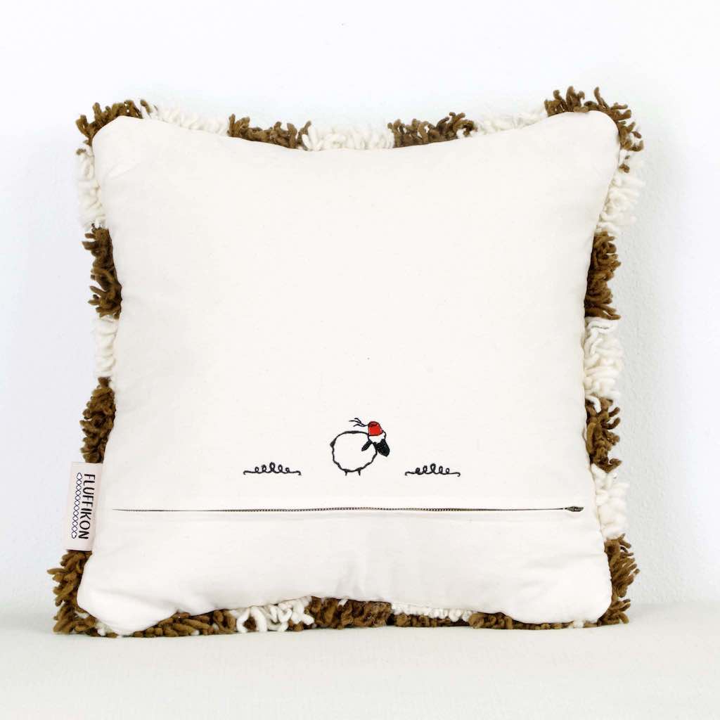 The back view of a brown checkered Moroccan Berber pillow in front of a white background.