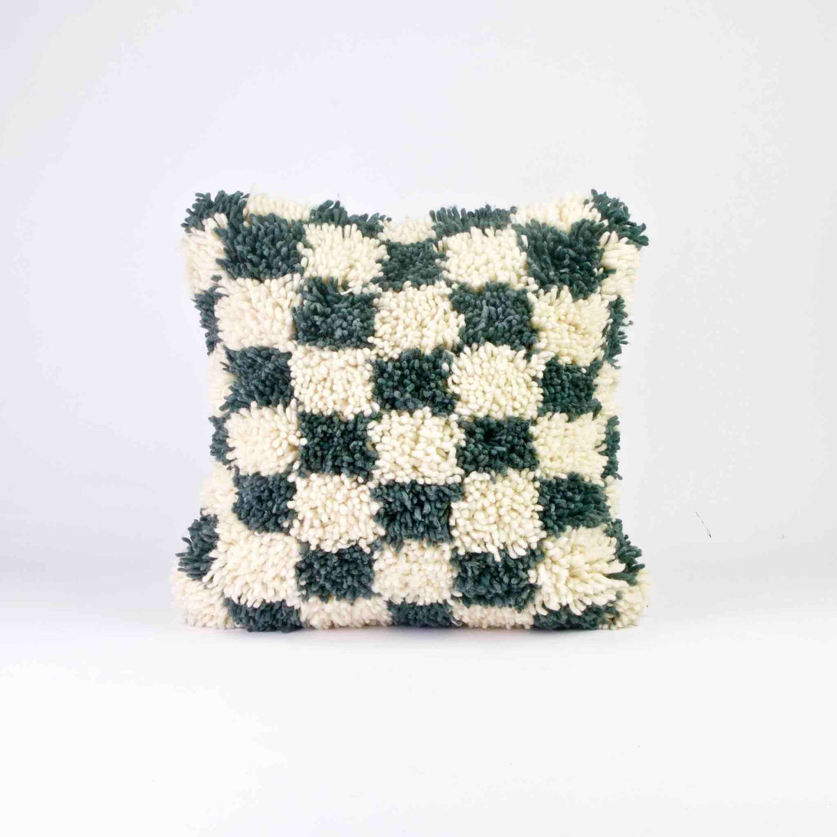 Checkered Moroccan Fluffikon pillow standing in front of a white background.