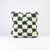 Checkered Moroccan Fluffikon pillow standing in front of a white background.