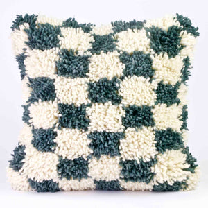 Zoom on checkered Moroccan Fluffikon pillow standing in front of a white background.
