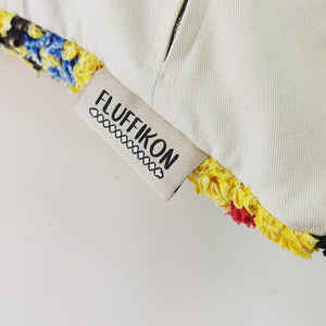 The video shows the back of a yellow Fluffikon Boucherouite Berber Cushion Cover.