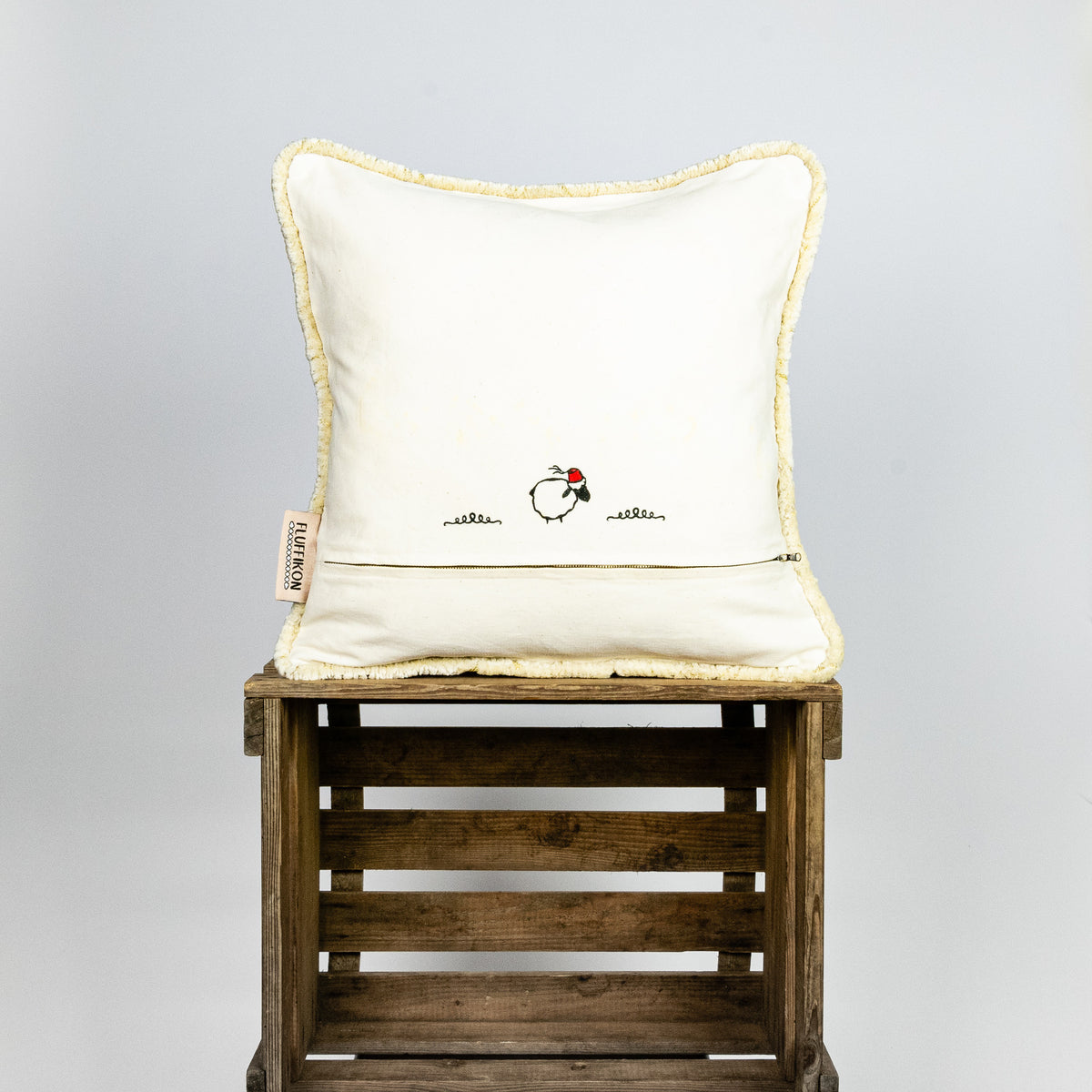 Fluffikon velvet square pillow made from beige moroccan fabric. The pillow is shown from the back.