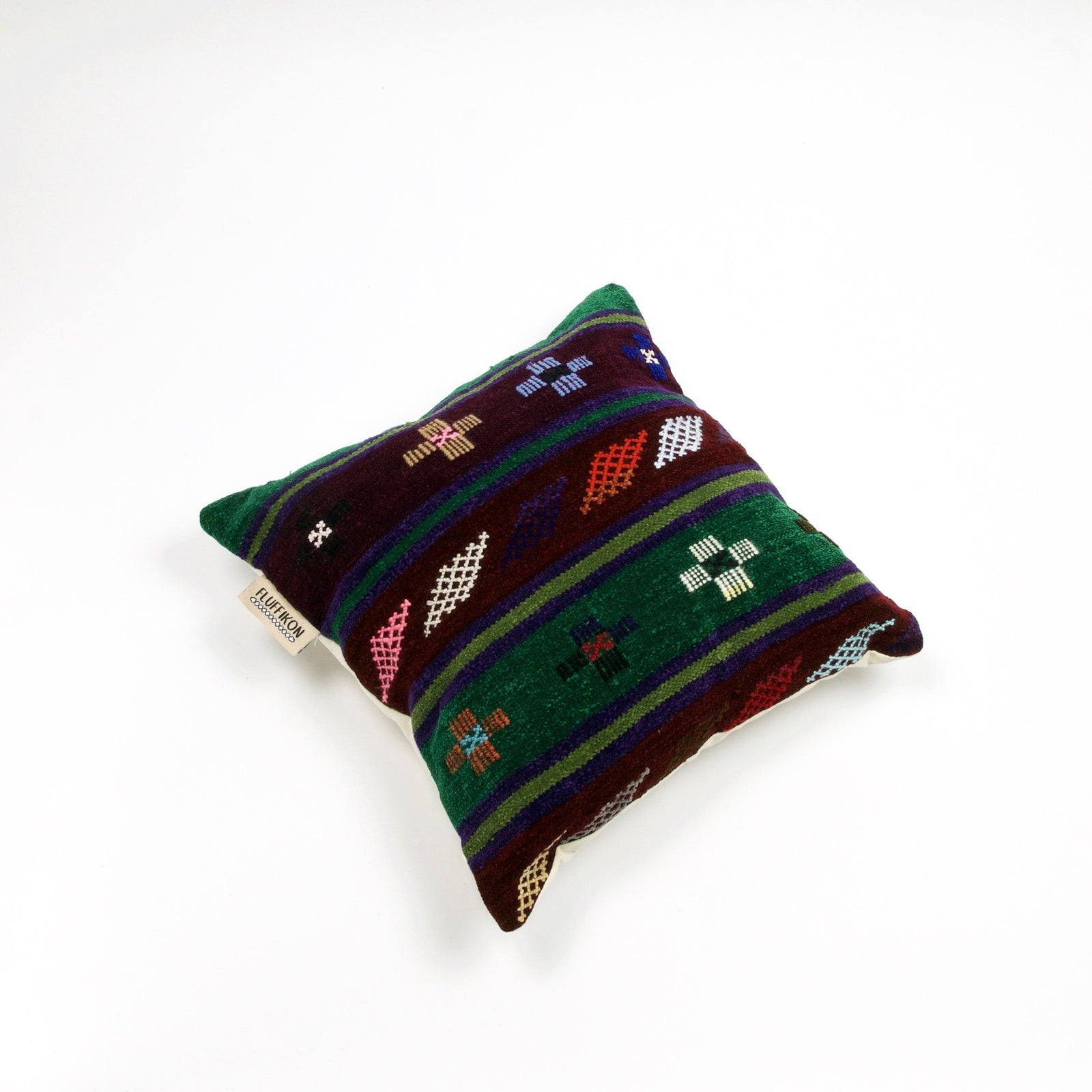 Fluffikon brown green decorative pillow with colourful berber symbols. It is made from a unique handmade thread rug.