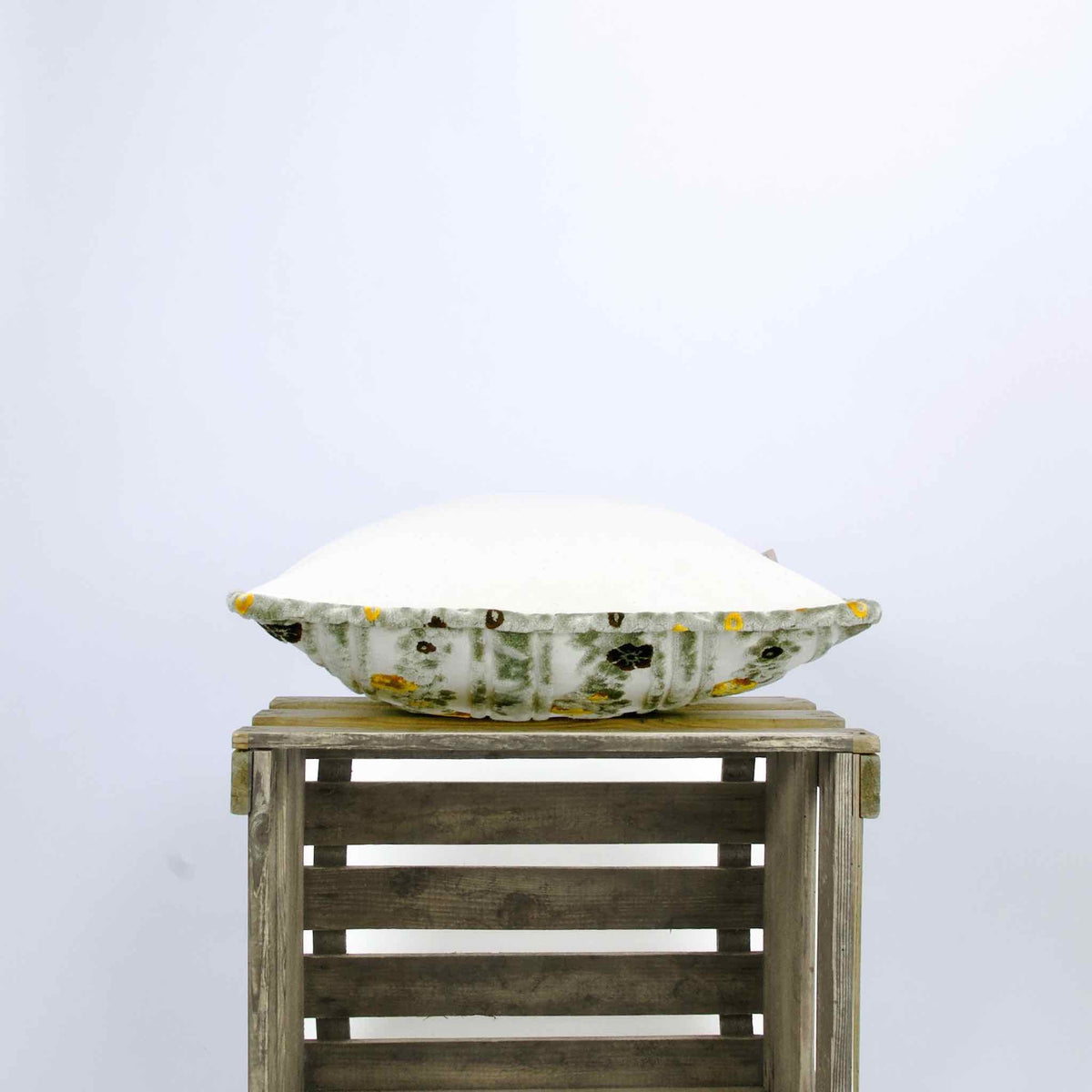 Side view of moroccan velvet throw pillow with piped edges.