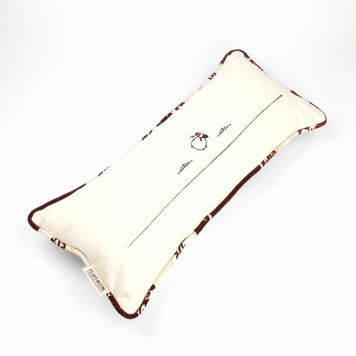 The back of a large couch pillow with moroccan piped edges.